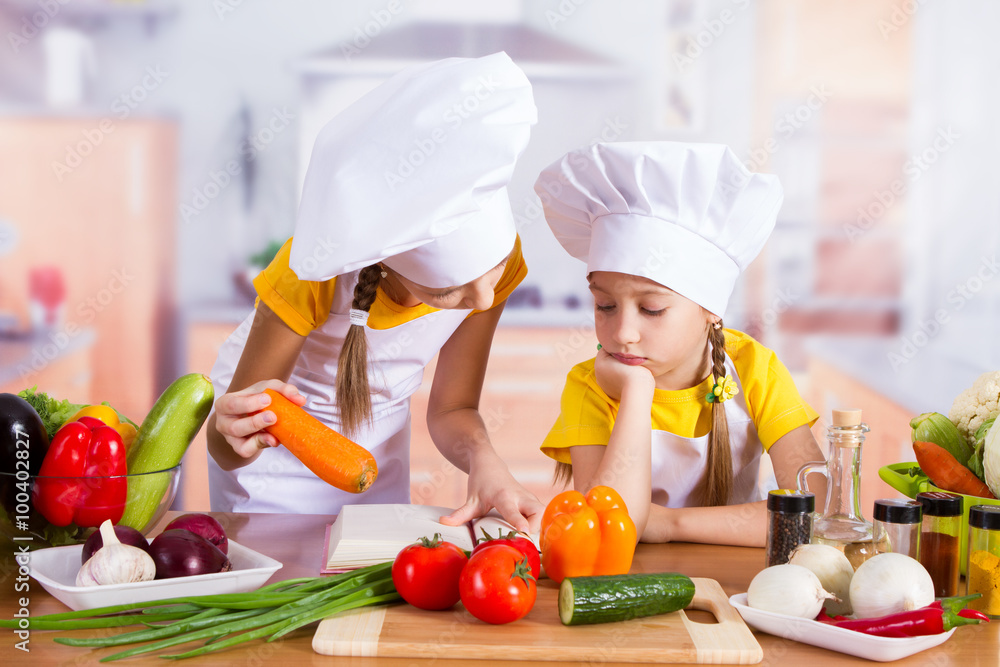 two girls looking for a recipe in the book two girls looking for a recipe in the book