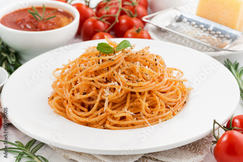 pasta with tomato sauce on a plate and ingredients  closeup