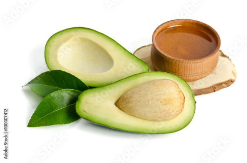 fresh avocado with avocado oil in the wooden bowl isolated on wh