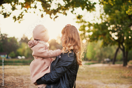 little girl in the arms of mother