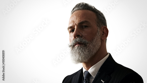 Close-up portrait of bearded gentleman wearing trendy suit. Horizontal photo