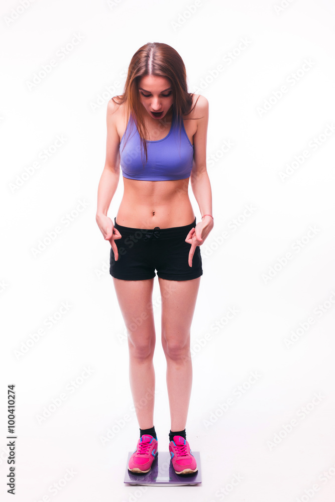 Sport girl Measuring Body Weight On Weighing Scale isolated on white background. Health concept Sport girl Measuring Body Weight On Weighing Scale isolated on white background. Health concept