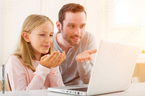 Father and his blond daughter videocalling