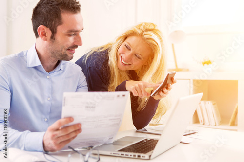 Attractive couple doing administrative paperwork