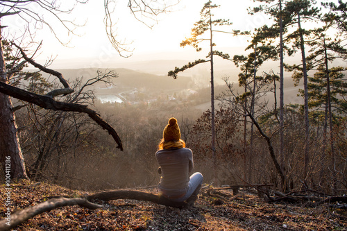 Girl sitting  in forest with beautiful view