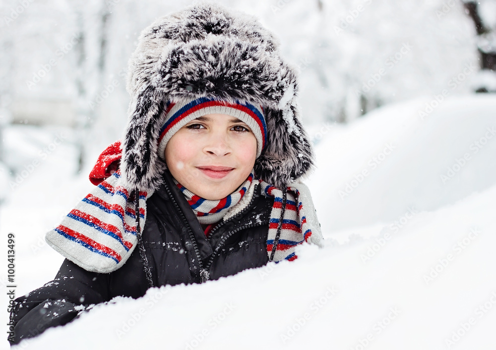 Smiling child with fluffy winter hat Smiling child with fluffy winter hat