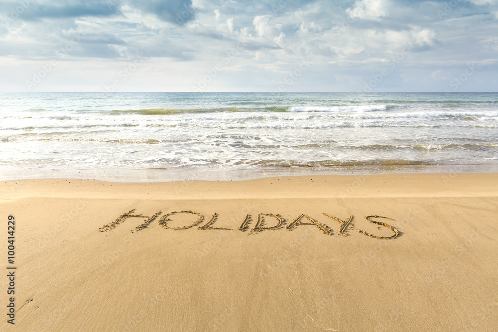 Fototapeta premium Writing in the sand. Family vacation in southern resorts.