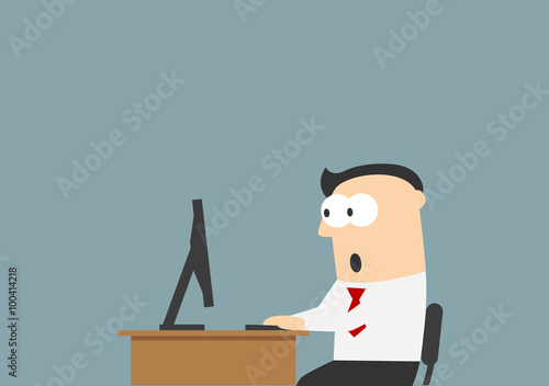 Shocked businessman looking at the monitor