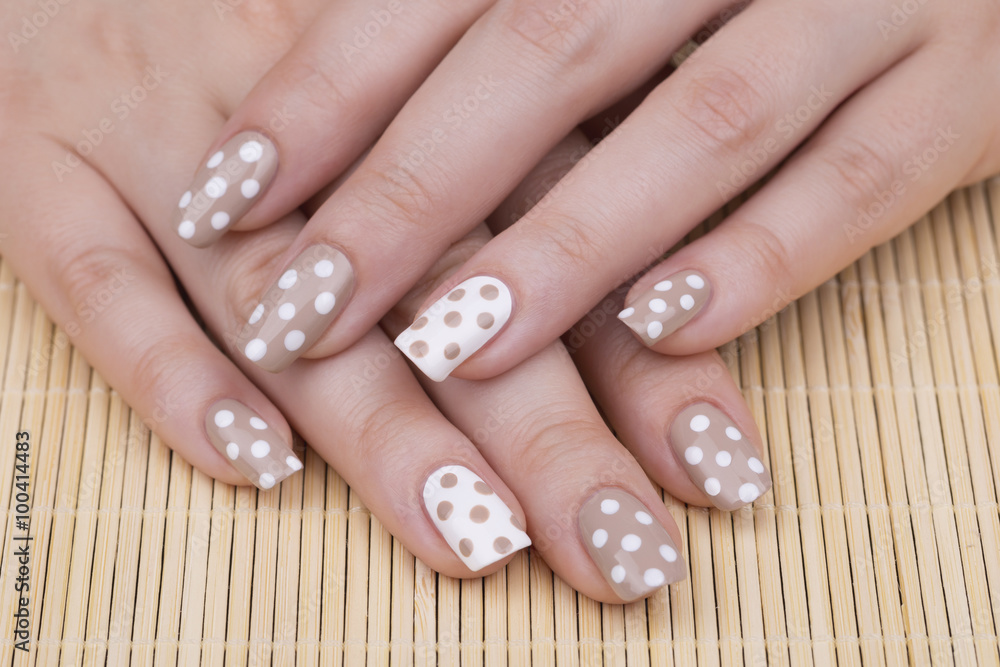 Beauty treatment photo of nice manicured woman fingernails. Very nice feminine nail art with nice nude and white nail polish. Beauty treatment photo of nice manicured woman fingernails. Very nice feminine nail art with nice nude and white nail polish.