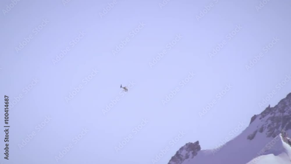 Shot of a helicopter flying over the Swiss alps Shot of a helicopter flying over the Swiss alps