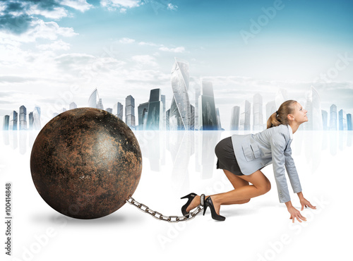 Businesswoman with iron ball