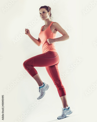 full-length photo of running woman over white background © Elena Kharichkina