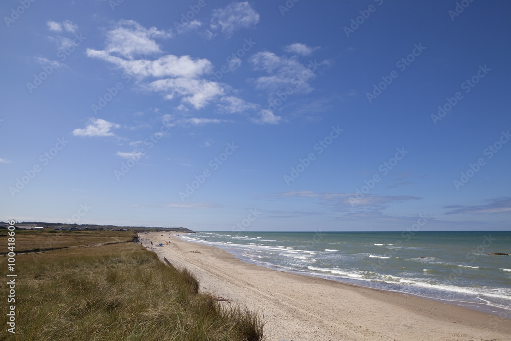 The Beach South of Hirtshal, Jutland. The beach south of Hirtshals is long and clean, full of white sand and rolling surf from the North Sea. It is a lovely summer destination.