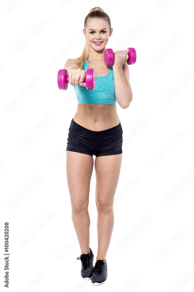 Lovely trainer working out with dumbbells Lovely trainer working out with dumbbells
