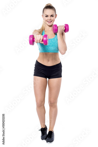 Lovely trainer working out with dumbbells