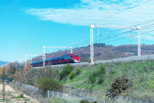Fast speeding up train in countryside railway