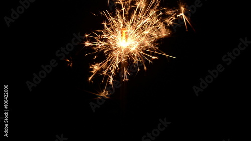 Burning christmas sparklers isolated on a black background. Two sparklers burning at once.
