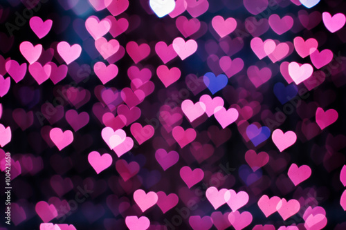 Blurring lights bokeh background of pink hearts