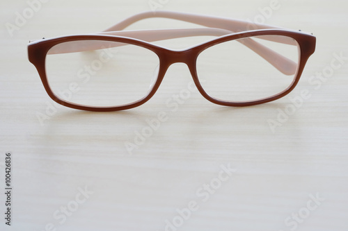 Eye glasses on wooden table