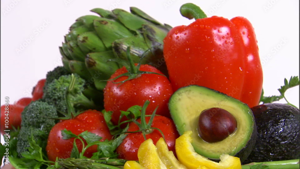 Zoom out shot of an assortment of vegetables rotating on a white screen. Zoom out shot of an assortment of vegetables rotating on a white screen.