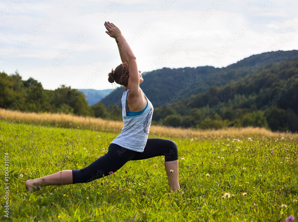 Young woman doing yoga in mountains at sunset time Young woman doing yoga in mountains at sunset time