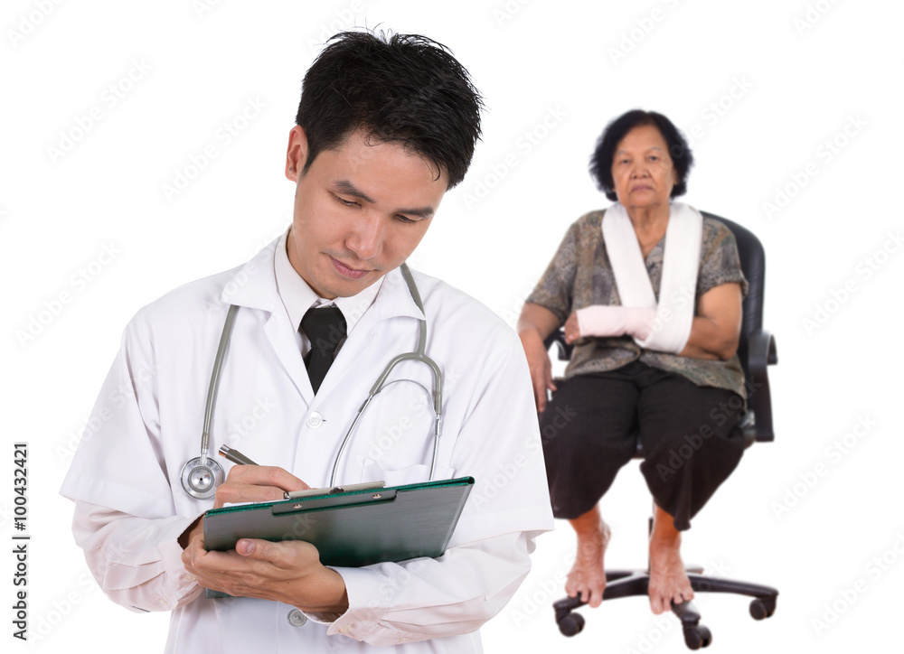 doctor writting medical report with senior woman injured arm doctor writting medical report with senior woman injured arm