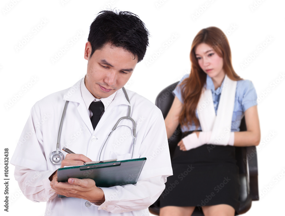 doctor writting medical report with woman injured arm doctor writting medical report with woman injured arm