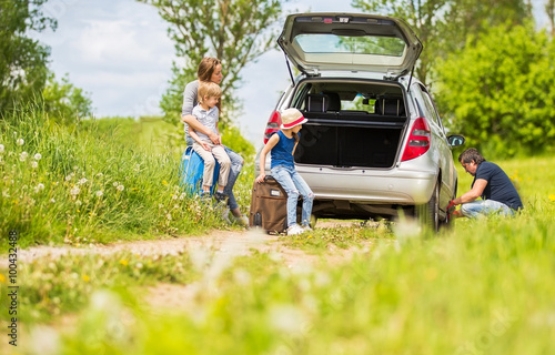 friendly family changes the tyre of the car