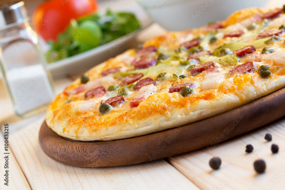 Homemade pizza with hunter sausages, bacon, peas and pickled cucumbers Homemade pizza with hunter sausages, bacon, peas and pickled cucumbers