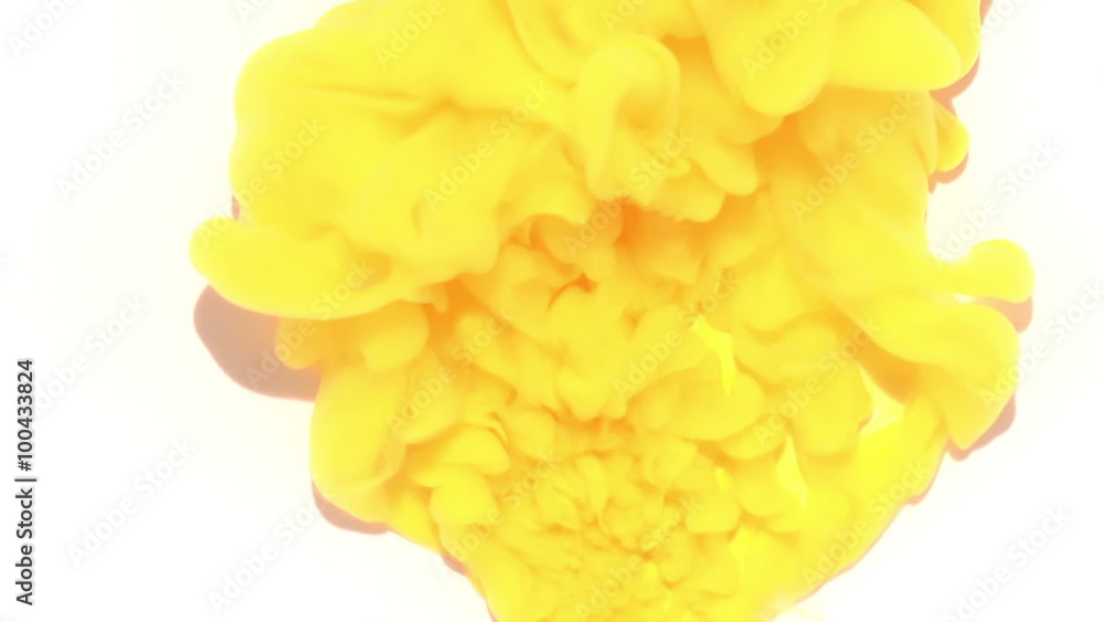 Yellow ink cloud forming underwater on white surface Yellow ink cloud forming underwater on white surface