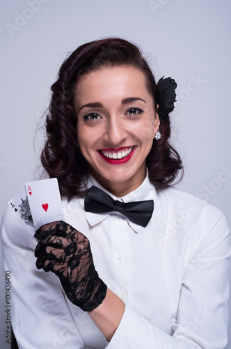 Smiling woman holding a pair of aces photo
