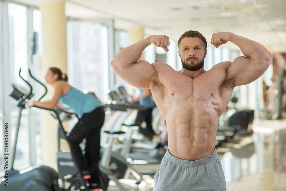 Muscular man in gym. Muscular man in gym.