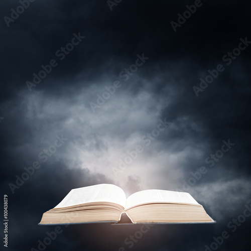 Opened book on a dark sky background