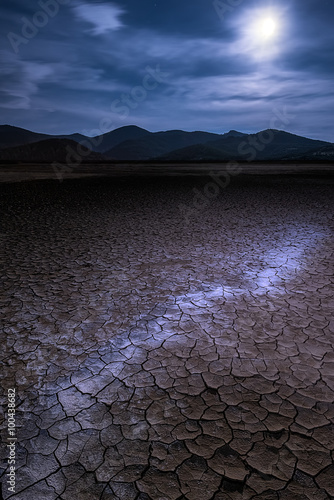 Cracked mud in moonlight, Prishtina, Kosovo photo