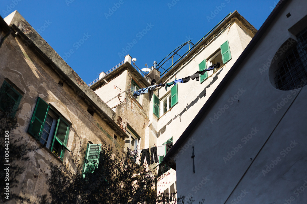 typical scene of hanging clothes in Genoa's streets, suny day,outdoor