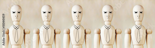 Wooden puppets as impersonal office staff stand in a row