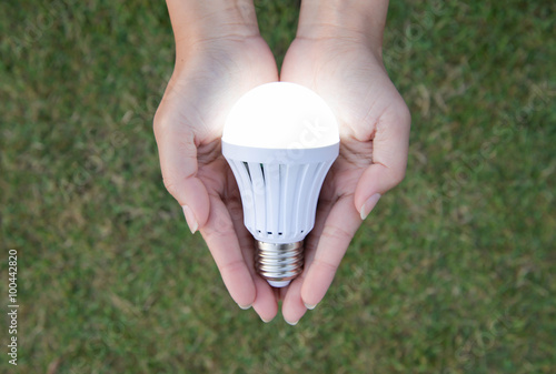 LED Bulb with lighting - saving technology in our hand photo