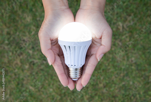 LED Bulb with lighting - saving technology in our hand photo