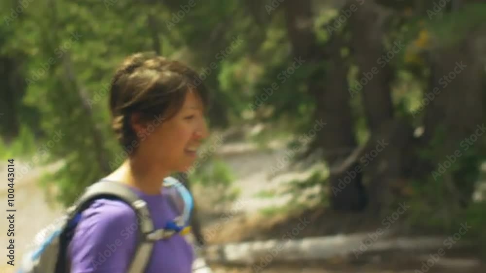 Attractive young woman smiles as she hikes Attractive young woman smiles as she hikes