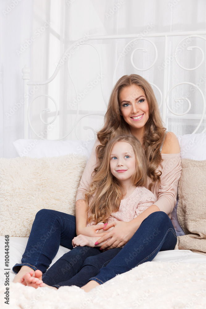 Pretty mother and daughter in the bed Pretty mother and daughter in the bed