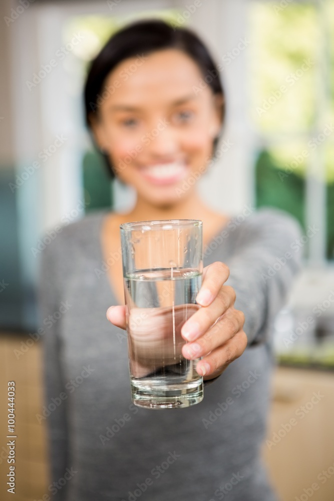 Smiling brunette holding glass of water Smiling brunette holding glass of water