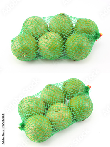 lemon in green Plastic Mesh Sack on White Background