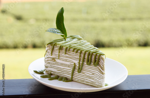 Green tea crepe cake on white disk