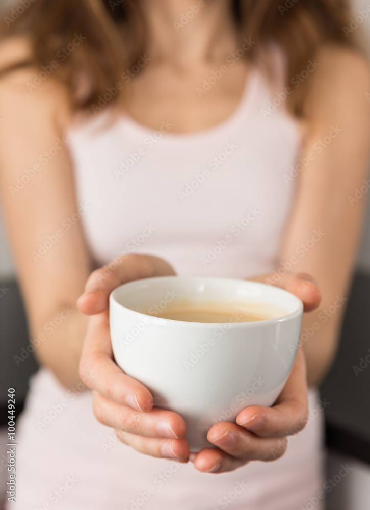 Woman holding coffee cup in her hands Woman holding coffee cup in her hands
