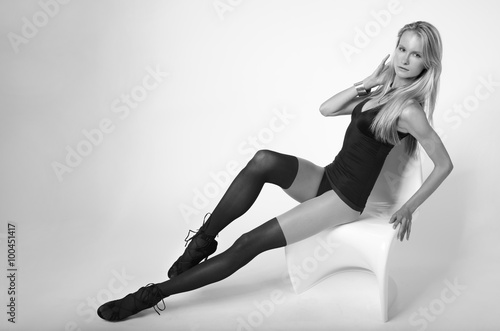 Model with sexy long legs posing pretty at white studio background