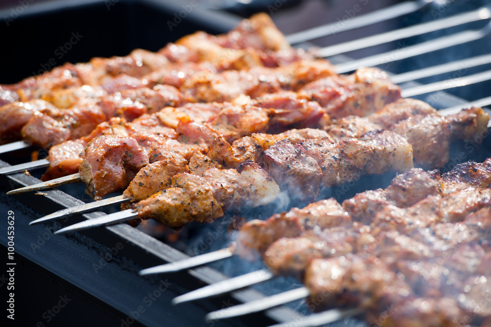 Grilling marinated shashlik on a grill. Shashlik is a form of Shish kebab  popular in Eastern, Central Europe and other places. Shashlyk meaning skewer  Stock Photo - Alamy