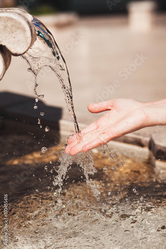 woman raised her hand to clean drinking water