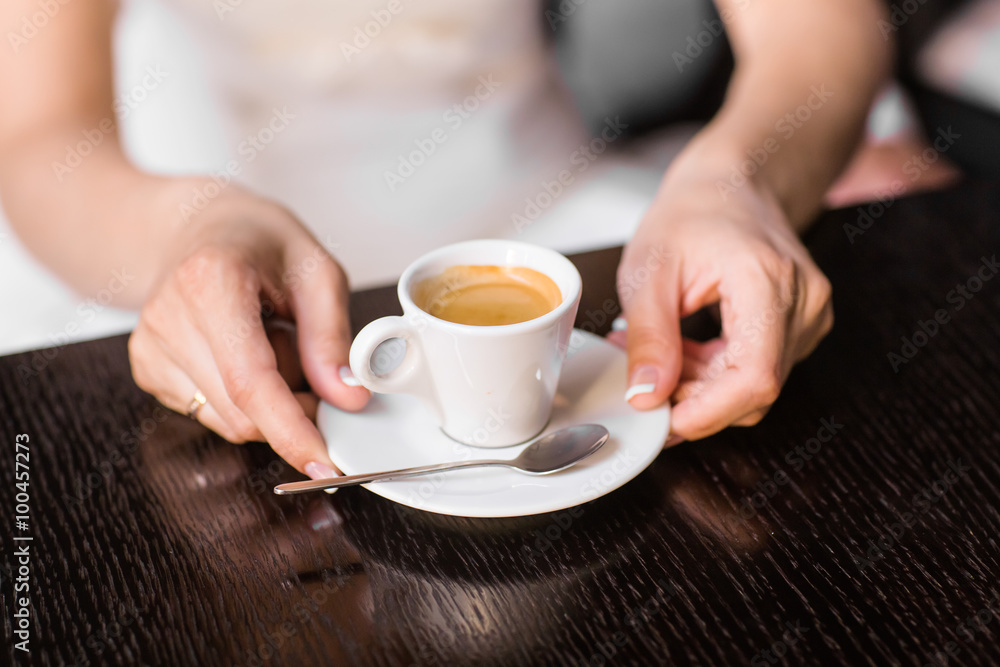 woman holding hot cup of coffee woman holding hot cup of coffee