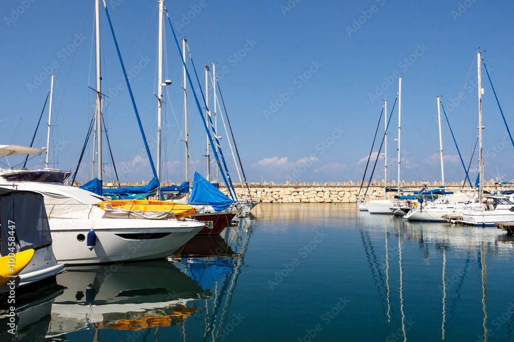 Boats reflected in the water. Herzliya Marina. Israel