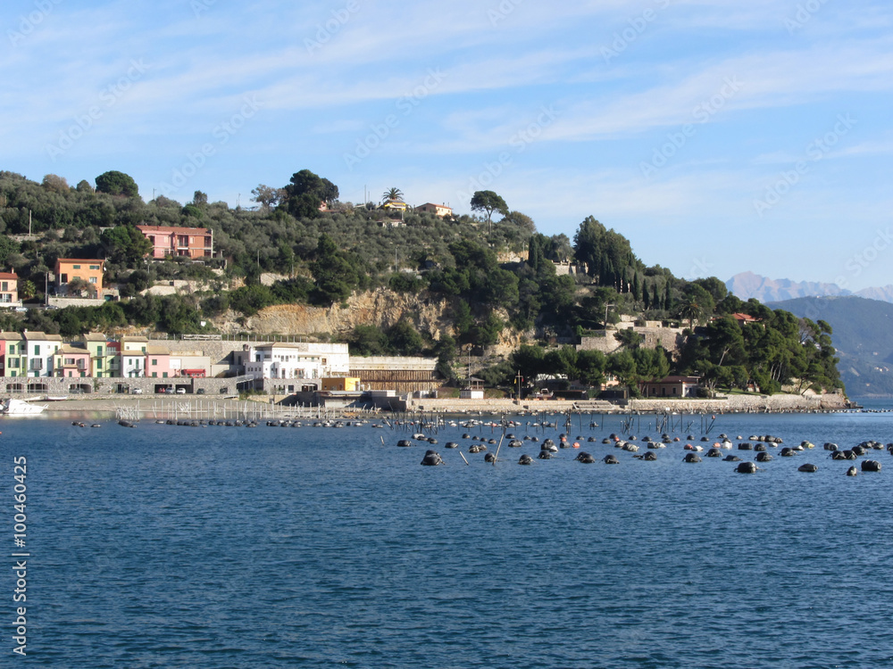 Landscape of Golfo Dei Poeti with its mussel farm in the sea. Province of La Spezia, Italy